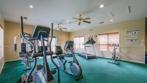 A gym with treadmills, elliptical machines, and a stationary bike. - Holiday Hills Resort at Branson (Branson)