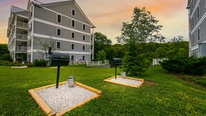 A multi-story residential building with a balcony, a well-maintained lawn, and two outdoor mailboxes. - Holiday Hills Resort at Branson (Branson)