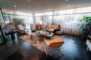 A spacious living room with a large window, a coffee table, and a sofa.
