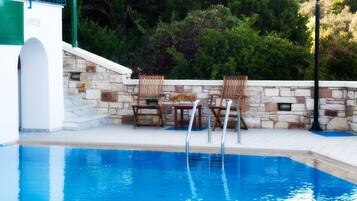 Outdoor pool, open 9:30 AM to 6 PM, pool loungers