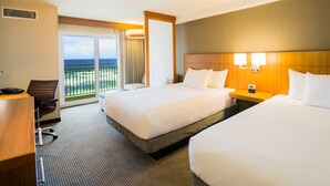 A hotel room with two beds, a desk, and a view of the ocean. - Hyatt Place Daytona Beach - Oceanfront (Daytona Beach Shores)
