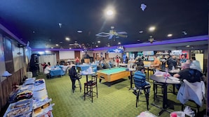 A bar area with pool tables, a buffet, and a bar counter. -  Pinckeyville Inn and Suites (Pinckneyville)
