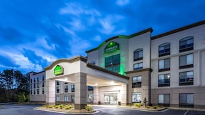 A Wingate by Wyndham hotel with a modern design, featuring a prominent entrance and multiple windows.