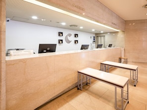 A reception desk with a marble counter, two desks, and a reception area with a ceiling light. - Comfort Hotel Hakata (Fukuoka)