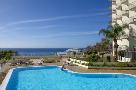 Outdoor pool, open 8:00 AM to 8:00 PM, pool umbrellas