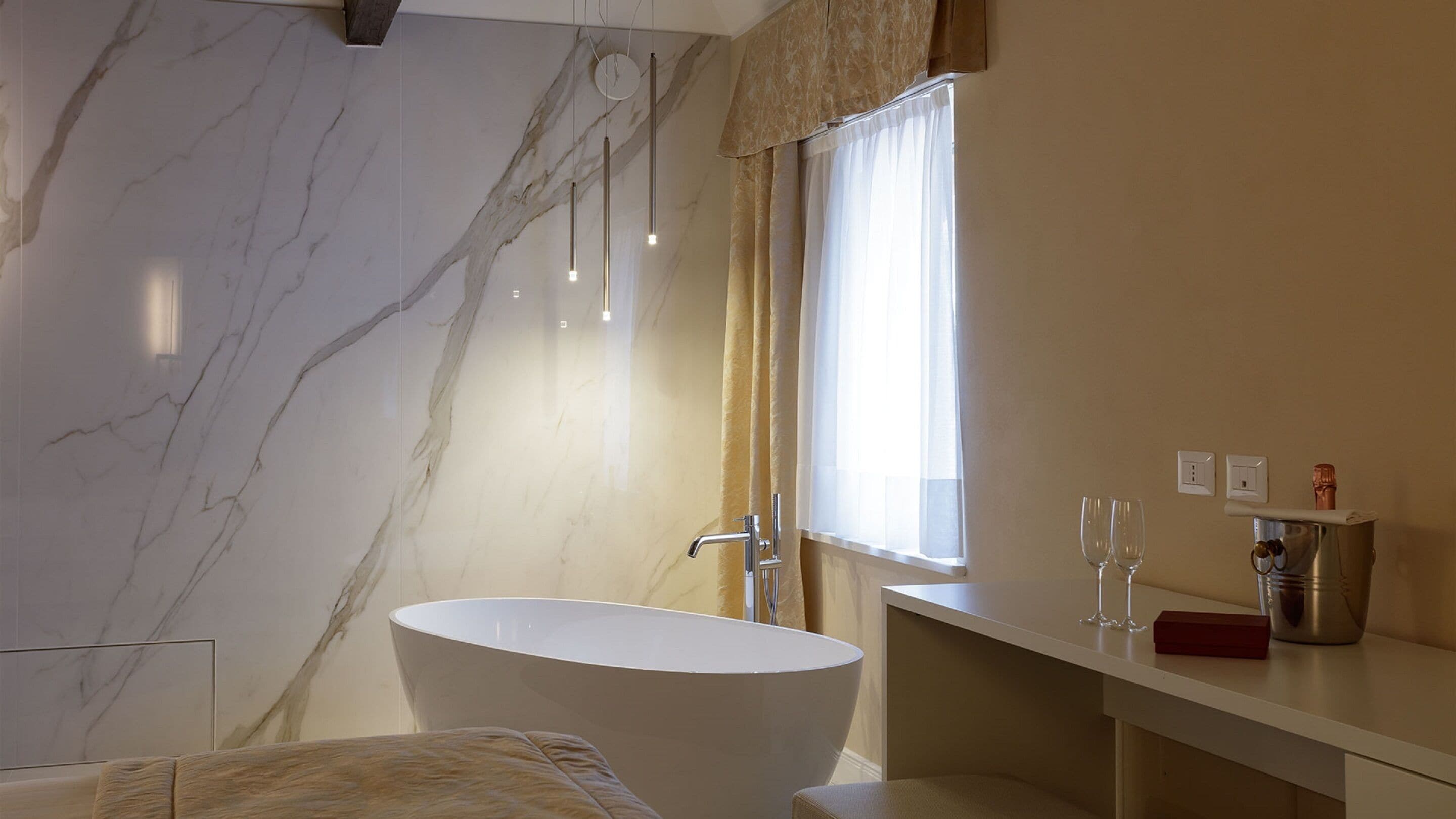 A modern bathroom with a freestanding bathtub, a vanity with a mirror, and a window with curtains.