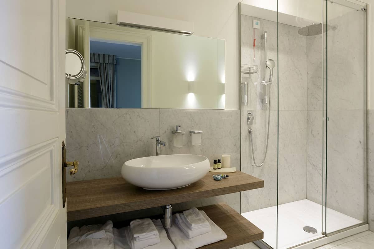 luxury suite, lake view | bathroom | hair dryer, towels