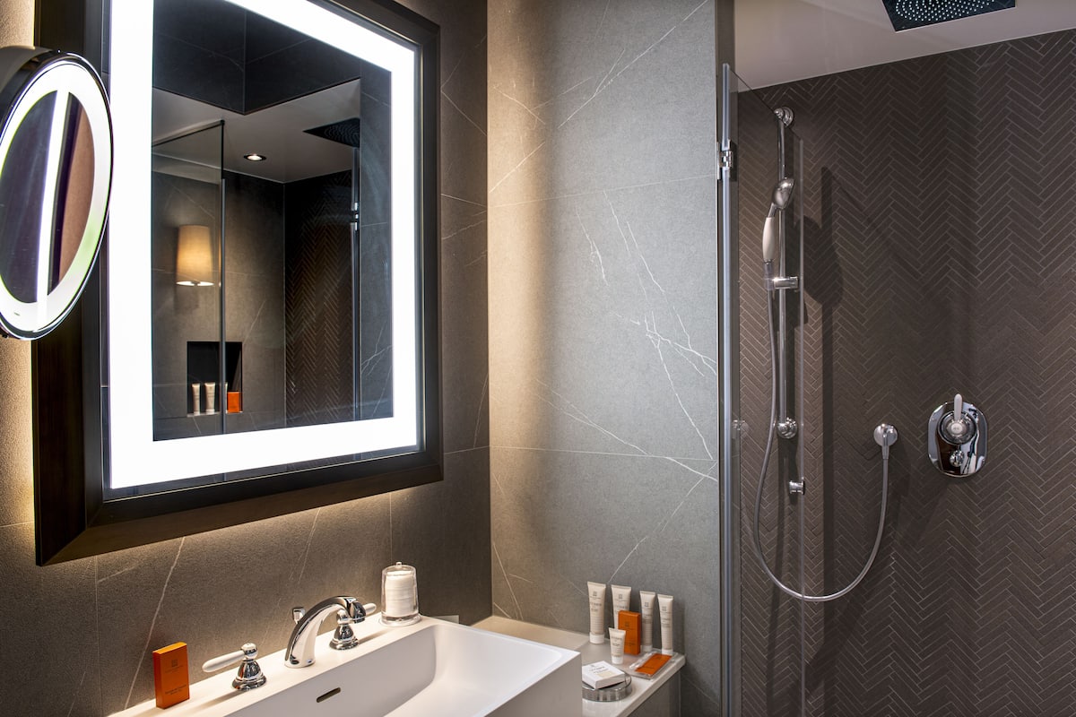 superior room | bathroom | rainfall showerhead, designer toiletries, hair dryer, bathrobes
