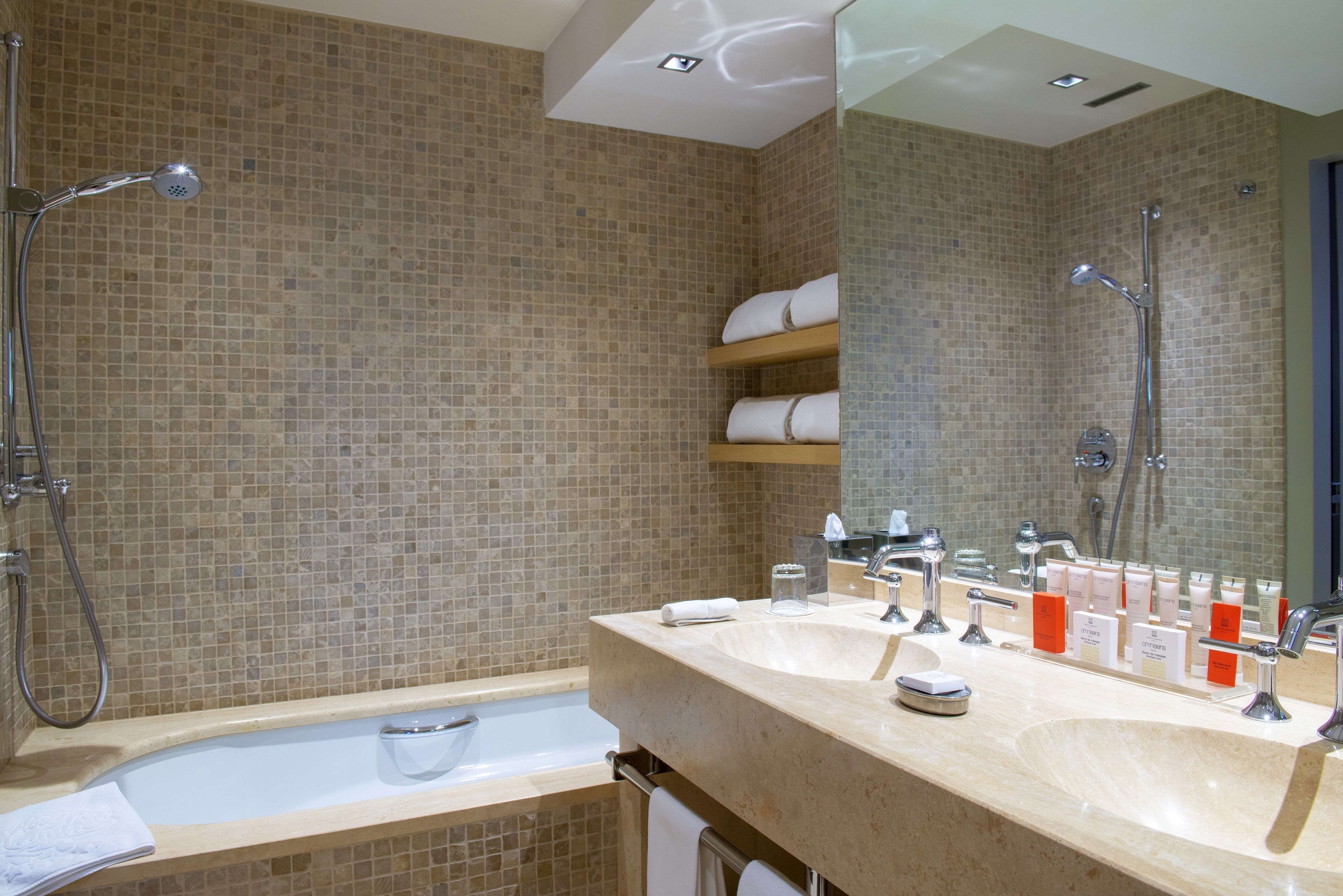 deluxe room | bathroom | rainfall showerhead, designer toiletries, hair dryer, bathrobes