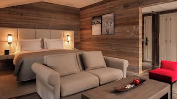 Un dormitorio moderno con una cama, un sofá, una mesa de centro y una silla roja.