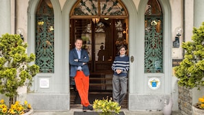A historic hotel entrance with a grand arched doorway, a sign indicating it's a Swiss historic hotel, and a small statue in the foreground. - Hôtel Masson (Veytaux)