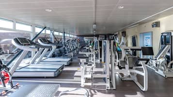 A gym with treadmills, weight machines, and exercise equipment.