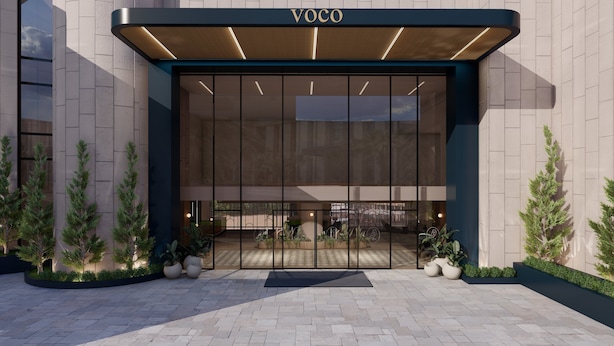 A modern building entrance with a large glass facade, a wooden canopy, and potted plants. - voco Beirut Central District by IHG (Beirut)