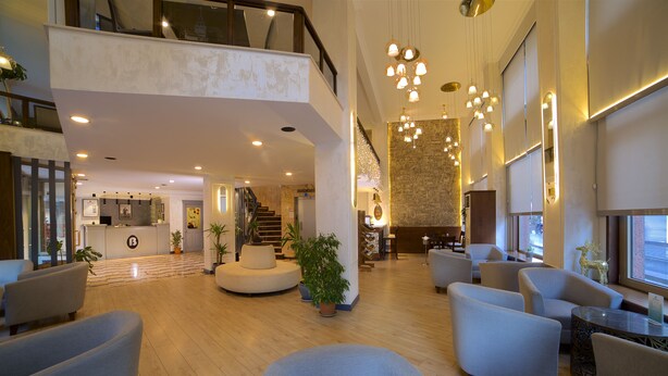 A spacious lobby with a high ceiling, multiple seating areas, and a staircase leading to an upper level. - Barin Hotel (Istanbul)