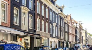 A row of traditional European-style buildings with storefronts, including a Michael Kors store. - Amsterdam Hostel Leidseplein (Amsterdam)