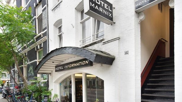 A hotel entrance with a sign for Hotel Marnix, a staircase, and a bike parking area. - Marnix Hotel (Amsterdam)
