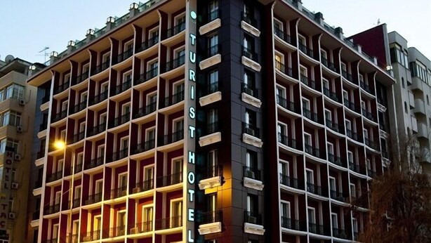 A multi-story hotel with a prominent "Turist Hotel" sign, featuring a grid of balconies and a modern architectural design. - Turist Hotel (Ankara)