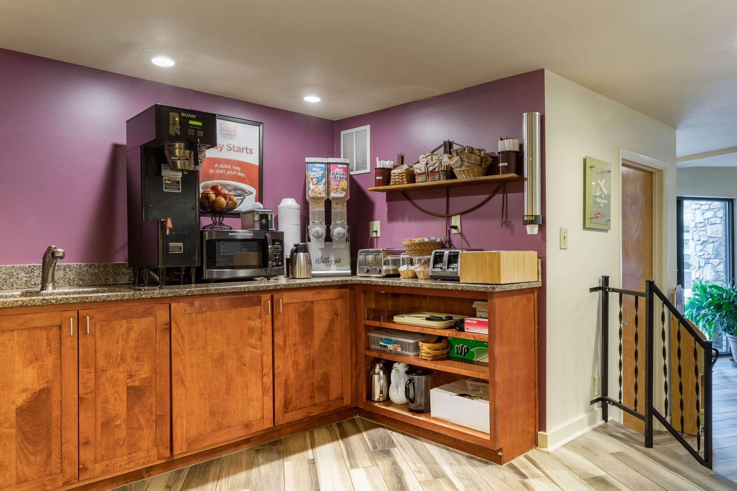 A kitchen with wooden cabinets, a microwave, a coffee maker, and a refrigerator.