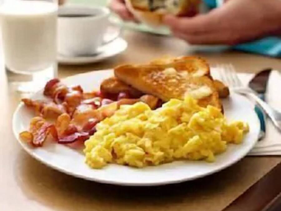 A breakfast plate with eggs, bacon, and toast.