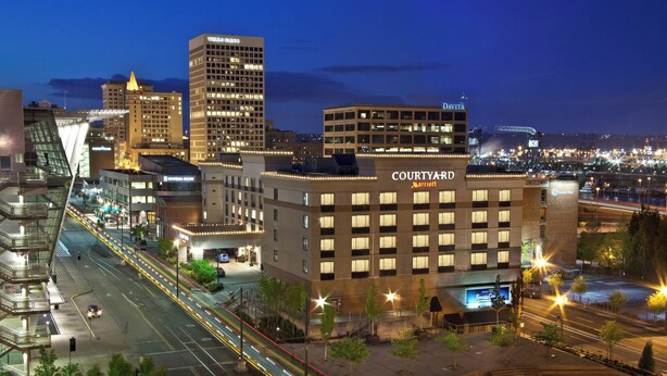 A Courtyard Marriott hotel with a modern design, located near a busy intersection with visible traffic. - Courtyard by Marriott Tacoma Downtown (Tacoma)