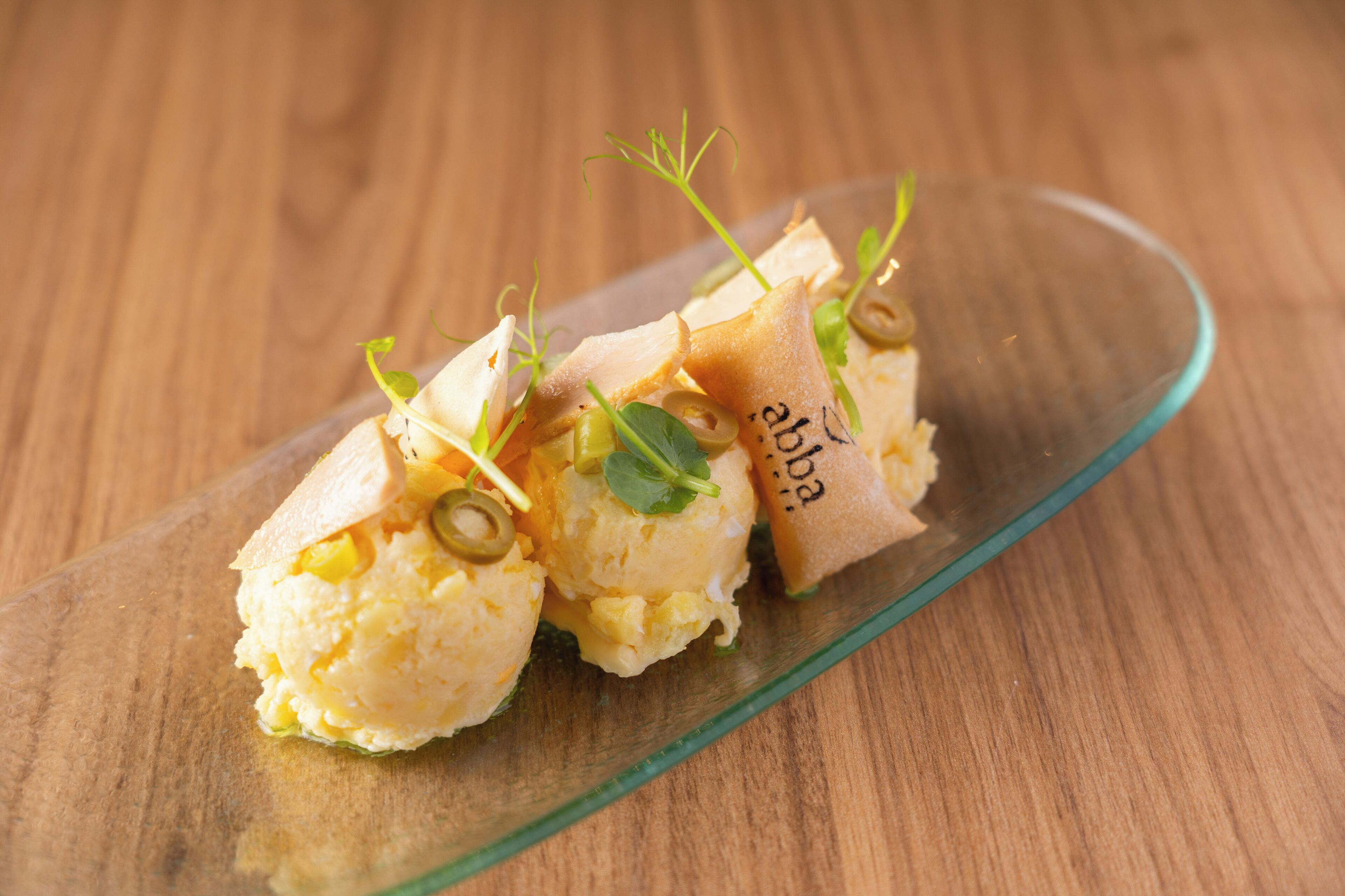 A dish with a glass plate on a wooden table.