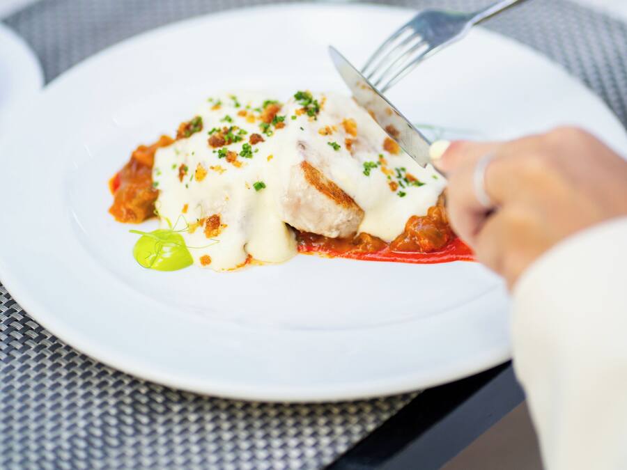 A plate of food with a fork and knife on a table.