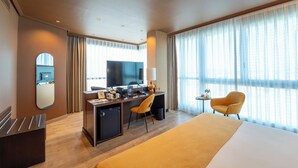A hotel room with a bed, desk, chair, and a television. - Abba Playa Gijon Hotel (Gijon)
