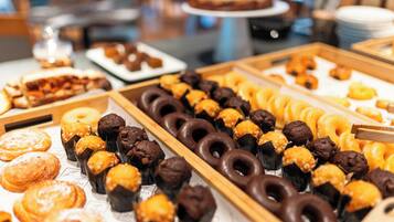 A buffet with various pastries and desserts.