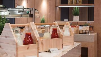 A beverage station with wooden crates containing bottles of milk and ketchup.