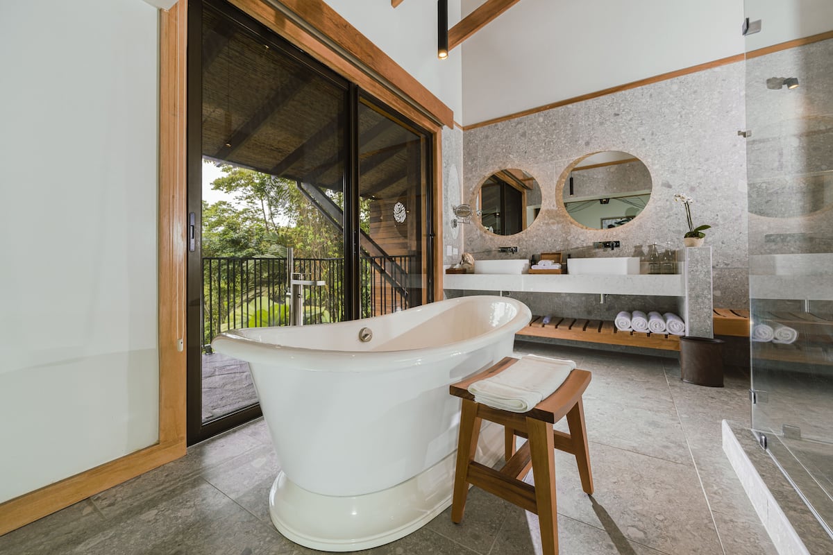 rainforest king bed | bathroom | shower, designer toiletries, hair dryer, bathrobes