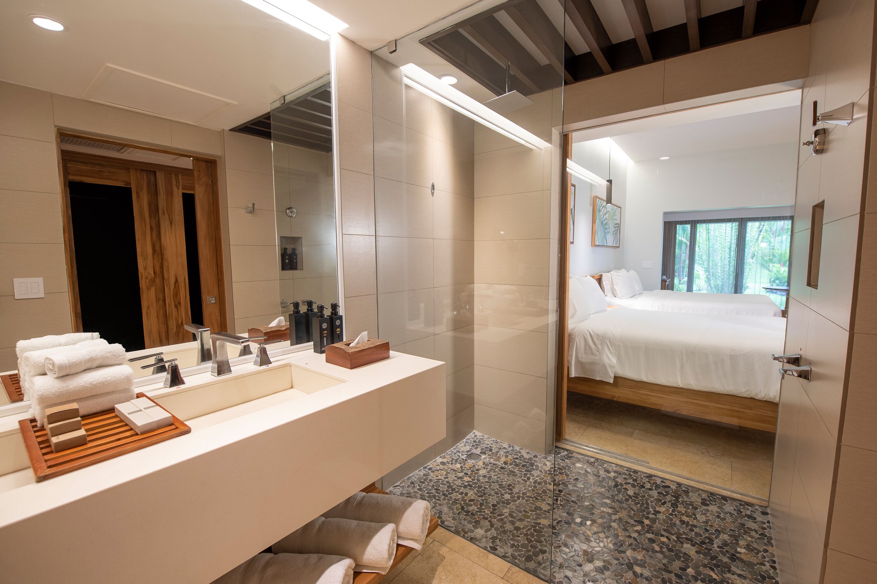 orchid room two queen beds | bathroom | shower, designer toiletries, hair dryer, bathrobes