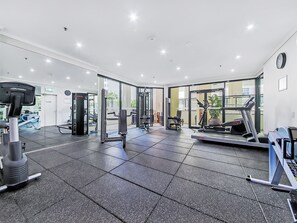 A gym with various exercise equipment, including treadmills and weight machines. - Quest River Park Central (Brisbane)