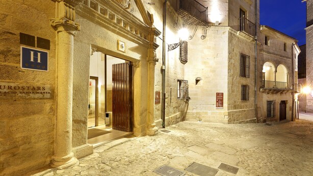 A historic building with a sign for "Eurostars" and a large entrance door. - Eurostars Palacio Santa Marta (Trujillo)