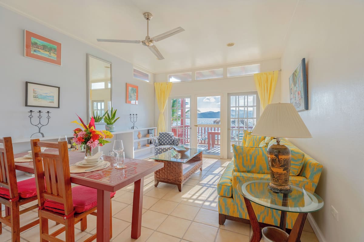 A dining area with a table, chairs, and a sofa.