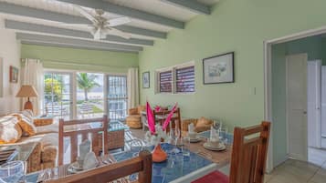Deluxe Villa, 2 Bedrooms, Ocean View, Beachfront | Living area | 21-inch TV with cable channels