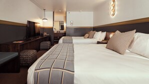 A hotel room with two beds, a desk, a television, and a mirror. - The Ozarker Lodge (Branson)