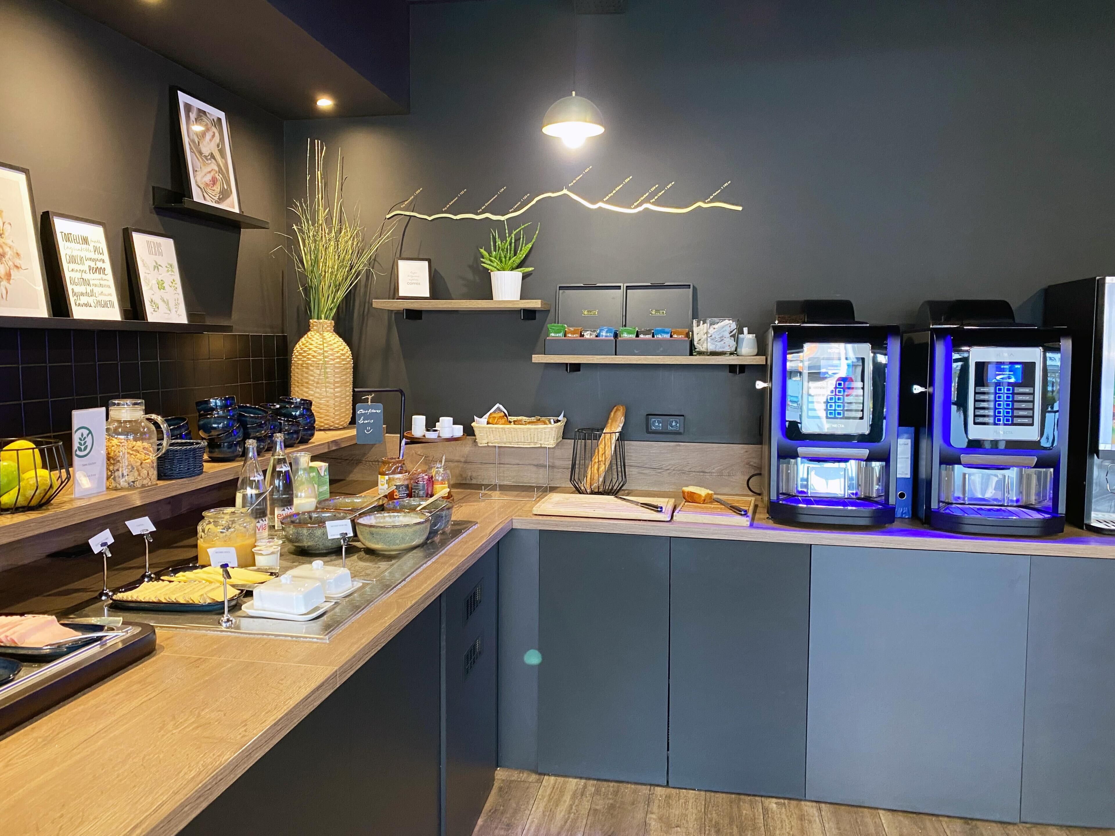 A modern coffee bar with a counter, coffee machines, and various breakfast items.
