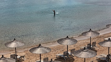 On the beach, white sand, sun-loungers, beach umbrellas
