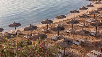 Plage, sable blanc, chaises longues, parasols