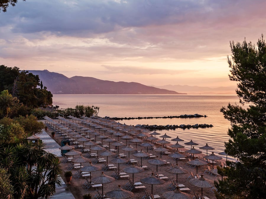 On the beach, white sand, sun loungers, beach umbrellas