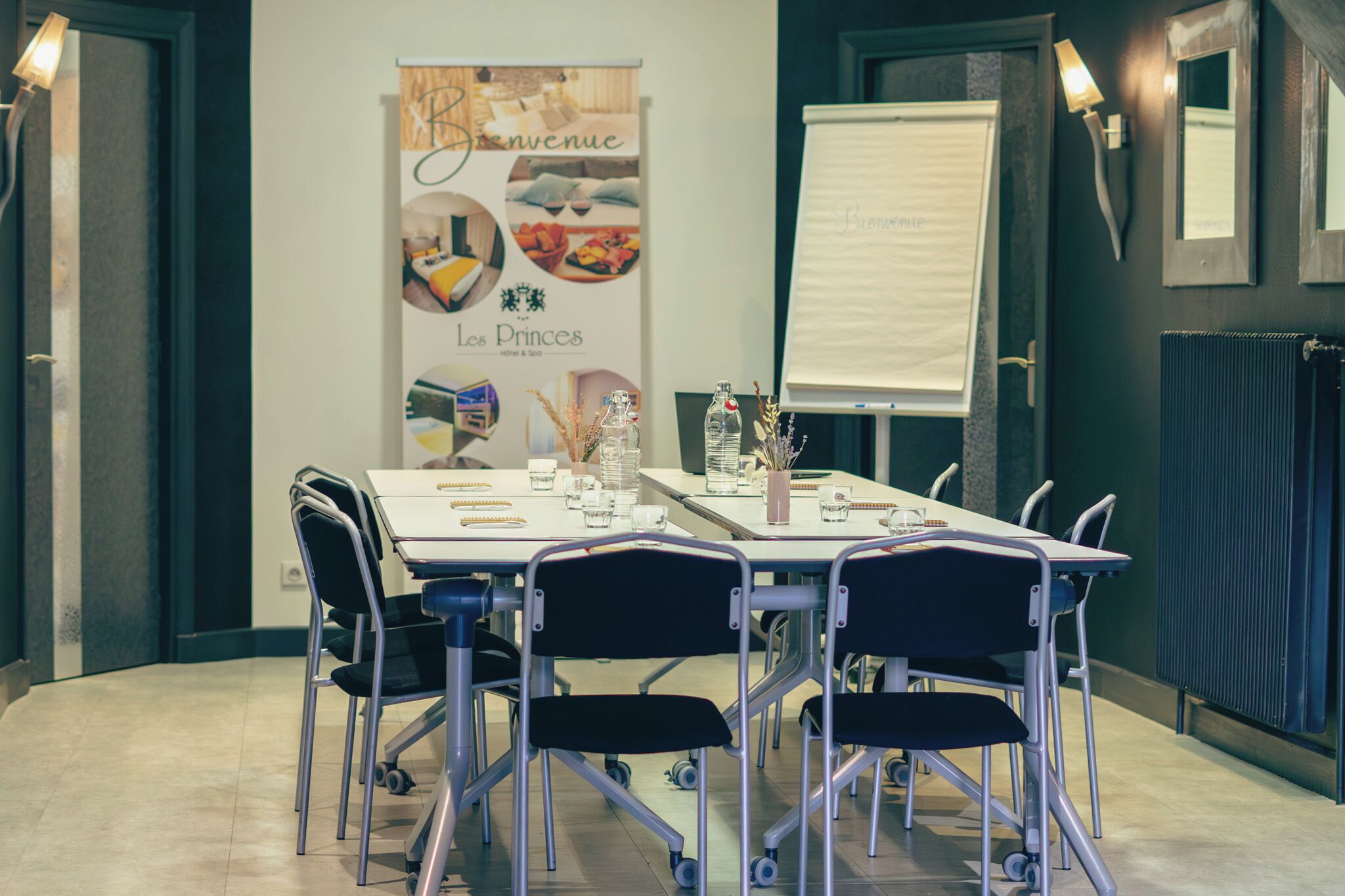 A conference room with a whiteboard, a banner, and a table with chairs.