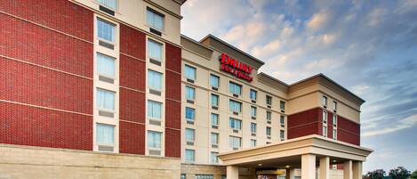 A Drury Inn hotel with a brick facade, multiple windows, and a clear sky.