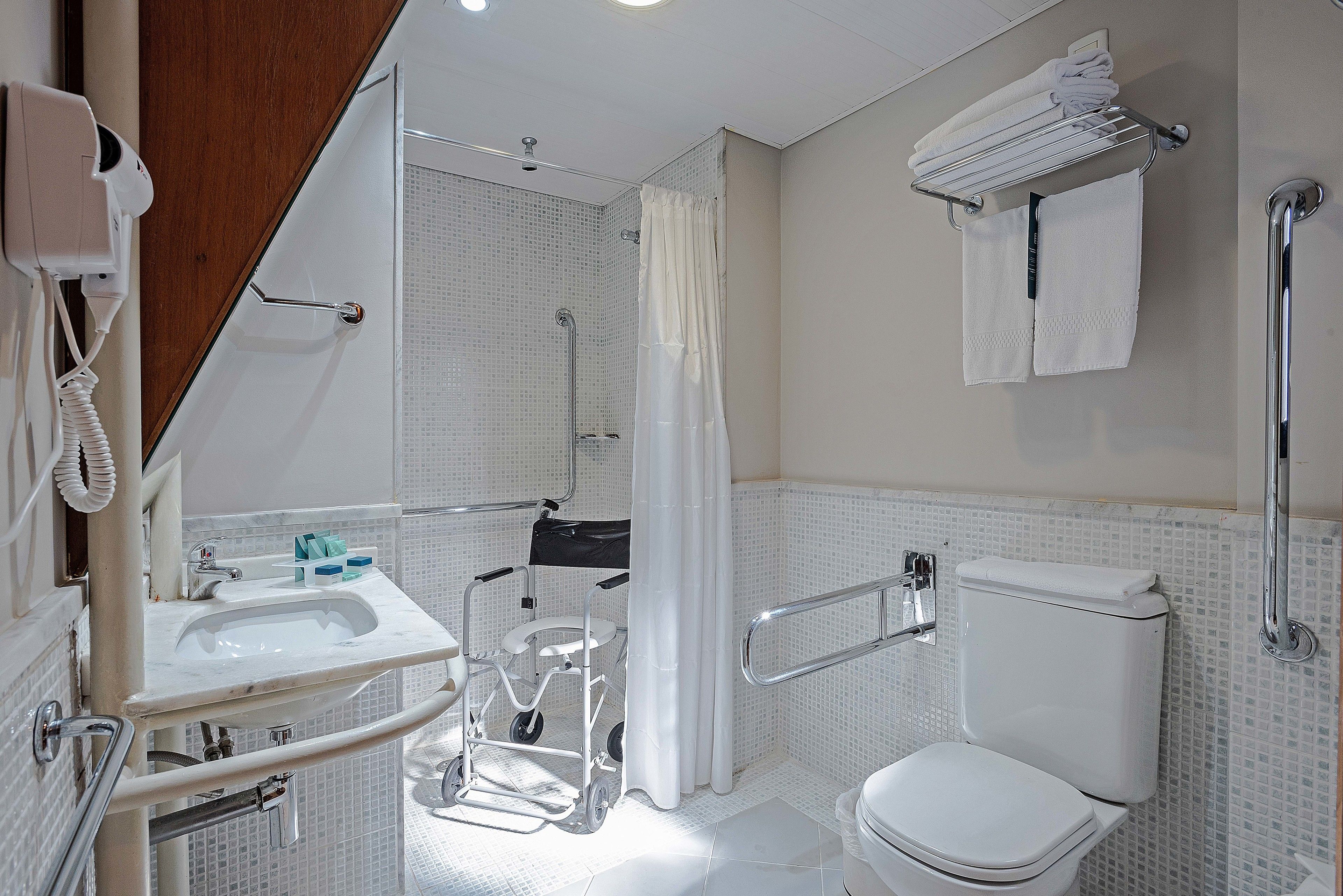 deluxe twin room, accessible | bathroom | shower, hair dryer, towels