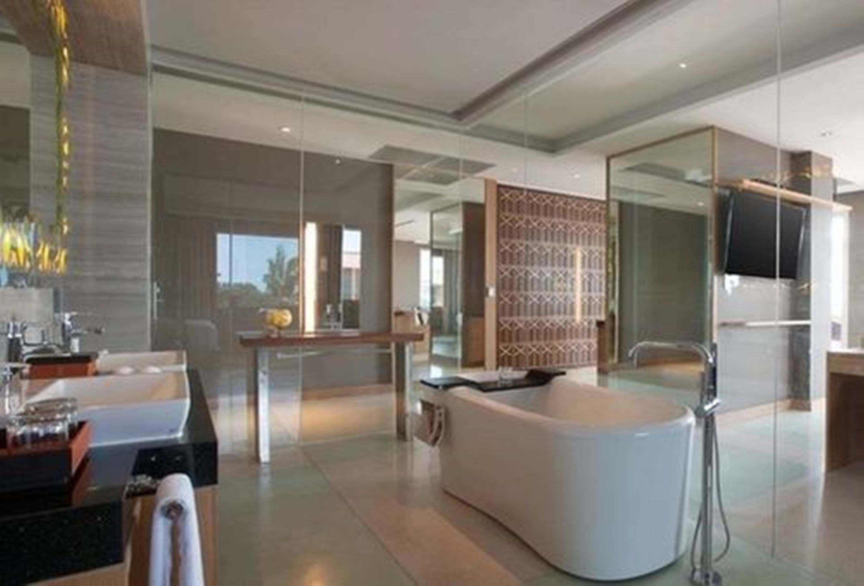 A modern bathroom with a freestanding bathtub, a glass shower enclosure, and a vanity with a sink and mirror.