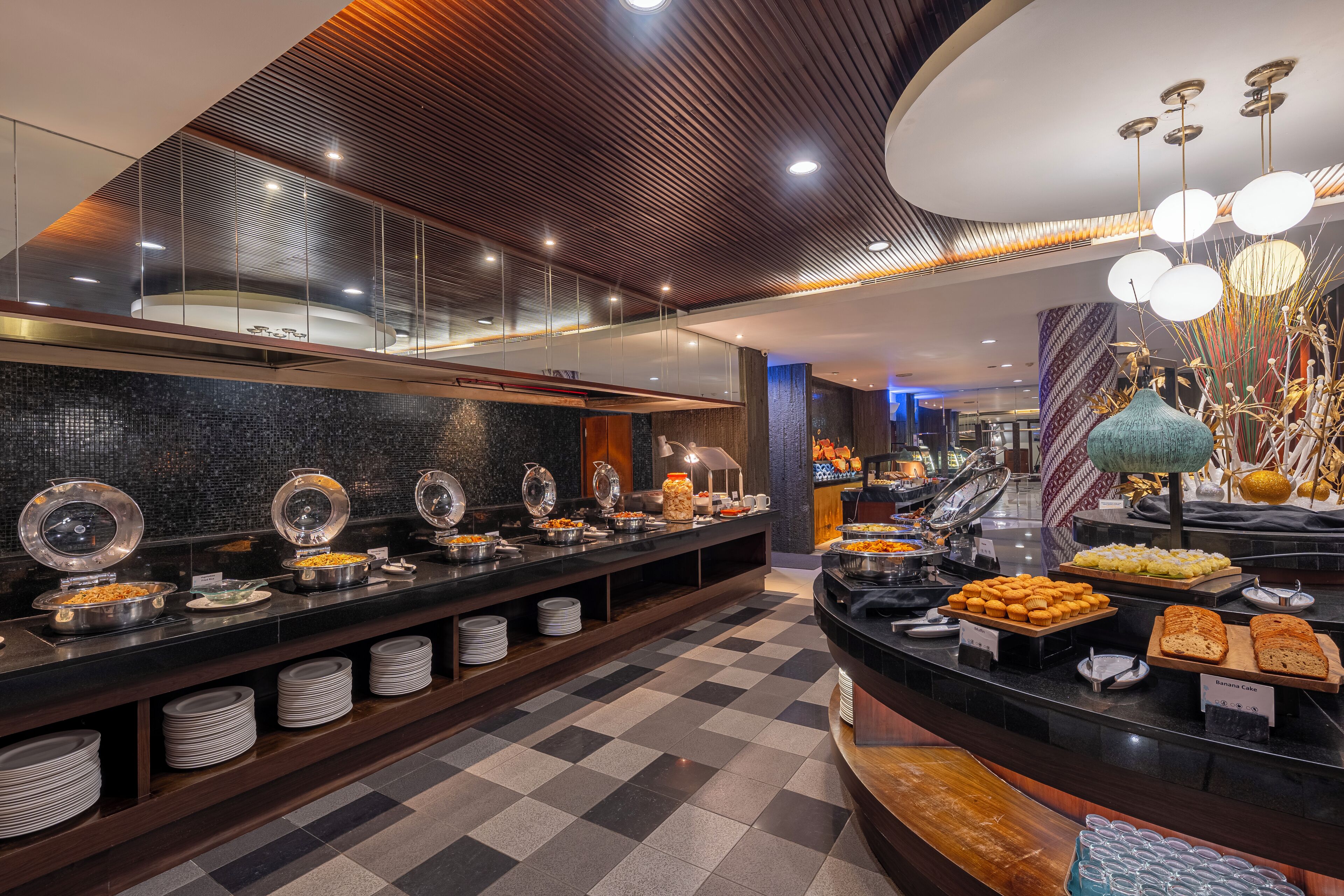 A buffet with various food items and a checkered floor.