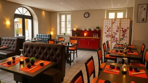 A restaurant with booths and tables, a kitchen area, and a decorative screen with flowers.