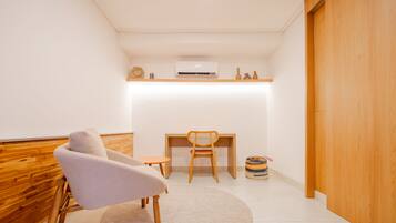 Relax in a stylish space with a round rug, a comfortable armchair, and a shelf.