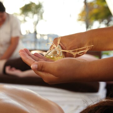 A massage therapy session with a person receiving a treatment.