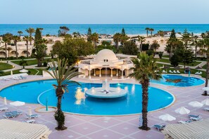 A resort with a large central pool, multiple smaller pools, and a dome-shaped building.