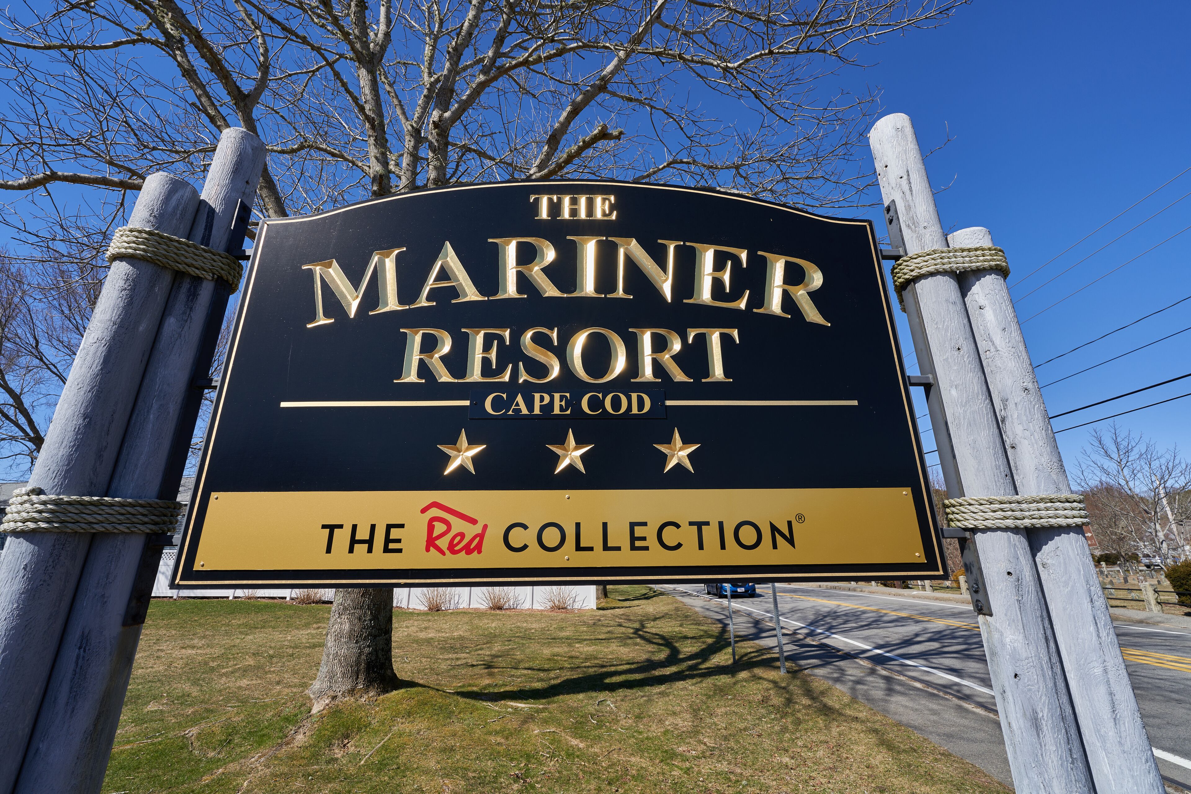 A sign for The Mariner Resort in Cape Cod, featuring a prominent logo and the text "The Red Collection".